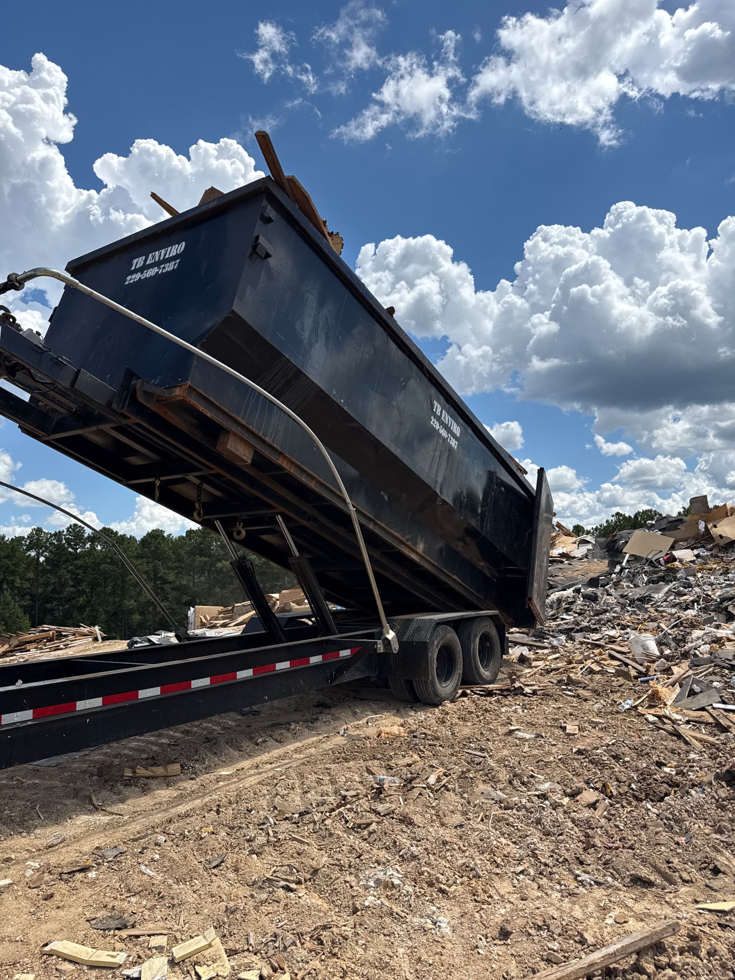 Roll-off container unloading construction debris